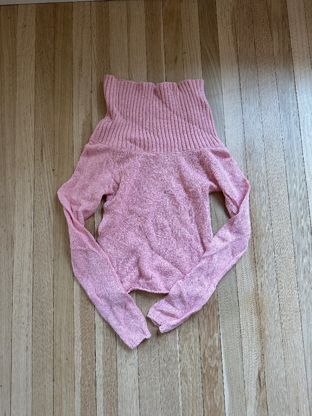 Subdued pink turtleneck or off the shoulder sweater
